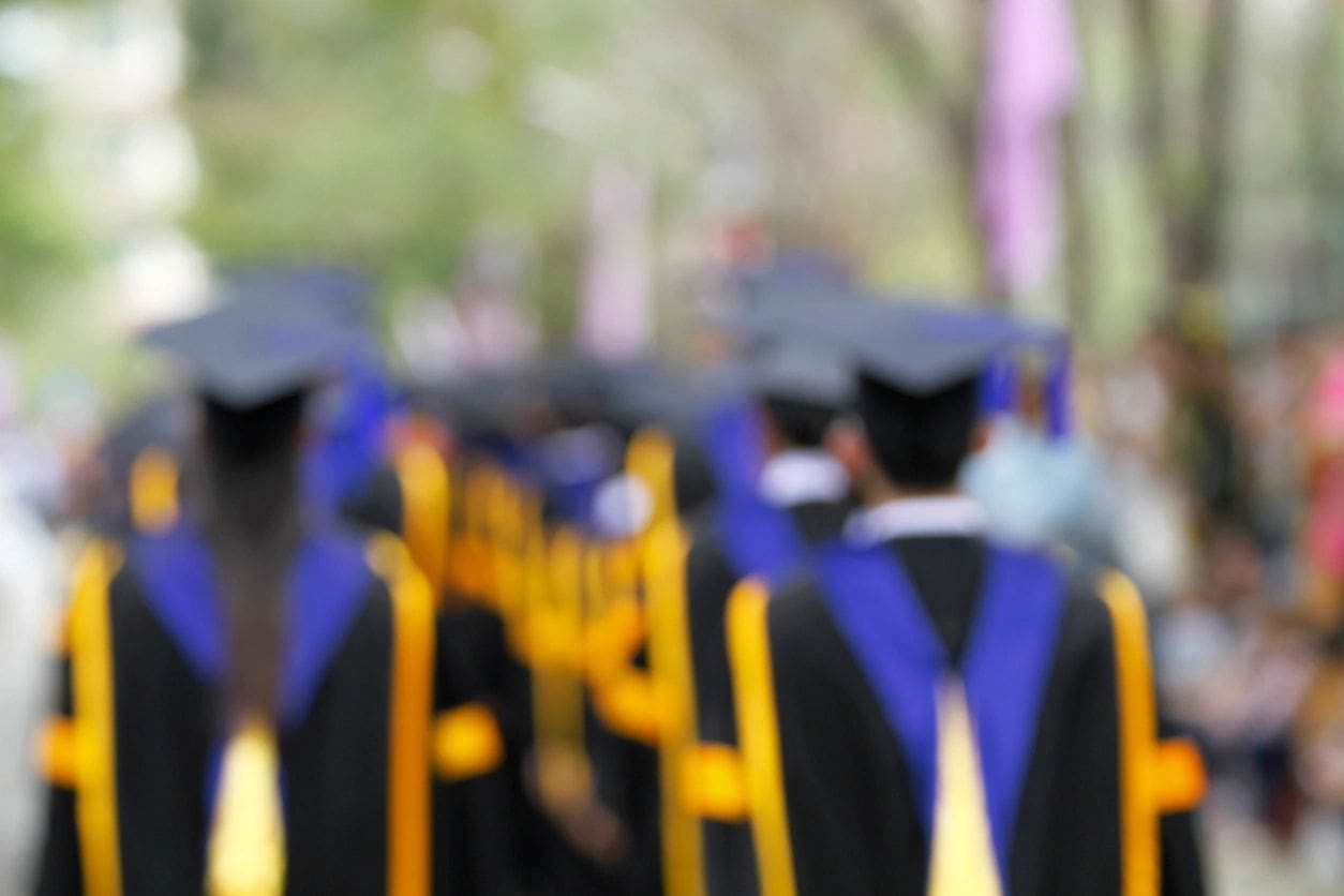 blurry of Graduates are walking the line to get a diploma and selective focus.